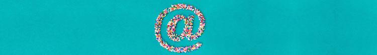Is email beauty only screen-deep. The 'at' symbol made from hundreds-and-thousands sprinkles on a turquoise background.