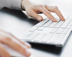 Email Signatures for College and University Students 1 A close up of hands typing at a keyboard.