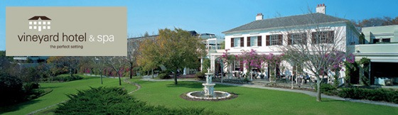 vineyard-hote-spa A grand old-fashioned house and established gardens, with the Vineyard Hotel & Spa logo superimposed on the corner.