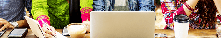7 reasons a demo will help you.fw A close-up of a man sitting behind a laptop, with people either side.