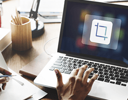 How to resize logos for your email signature 5 A close-up of a woman's hand typing on a laptop.