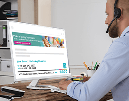 7 ways your email signatures can meet the challenges of remote working 14 A man wearing a phone headset types at a desktop computer with a Rocketseed email banner & signature on screen.