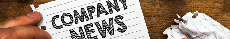 News Header The words "COMPANY NEWS" hand-written on lined paper, with a man's hand in the corner of the shot.