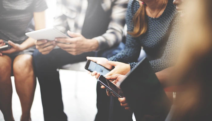 How to standardize a company email signature? 14 A group of people sitting in a circle on their mobile devices